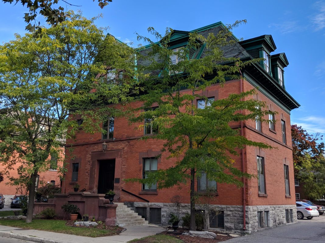 Exterior of the Sandy Hill Wellness clinic, a red-brick heritage building on Chapel Street in Ottawa